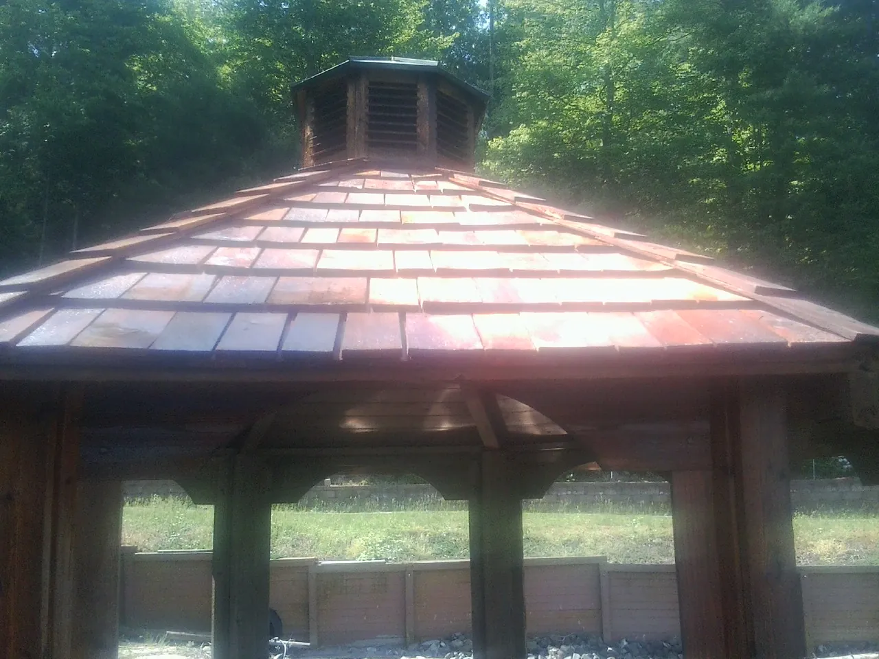 New cedar shake roof and cupola on a lakeside gazebo in Pine Prairie